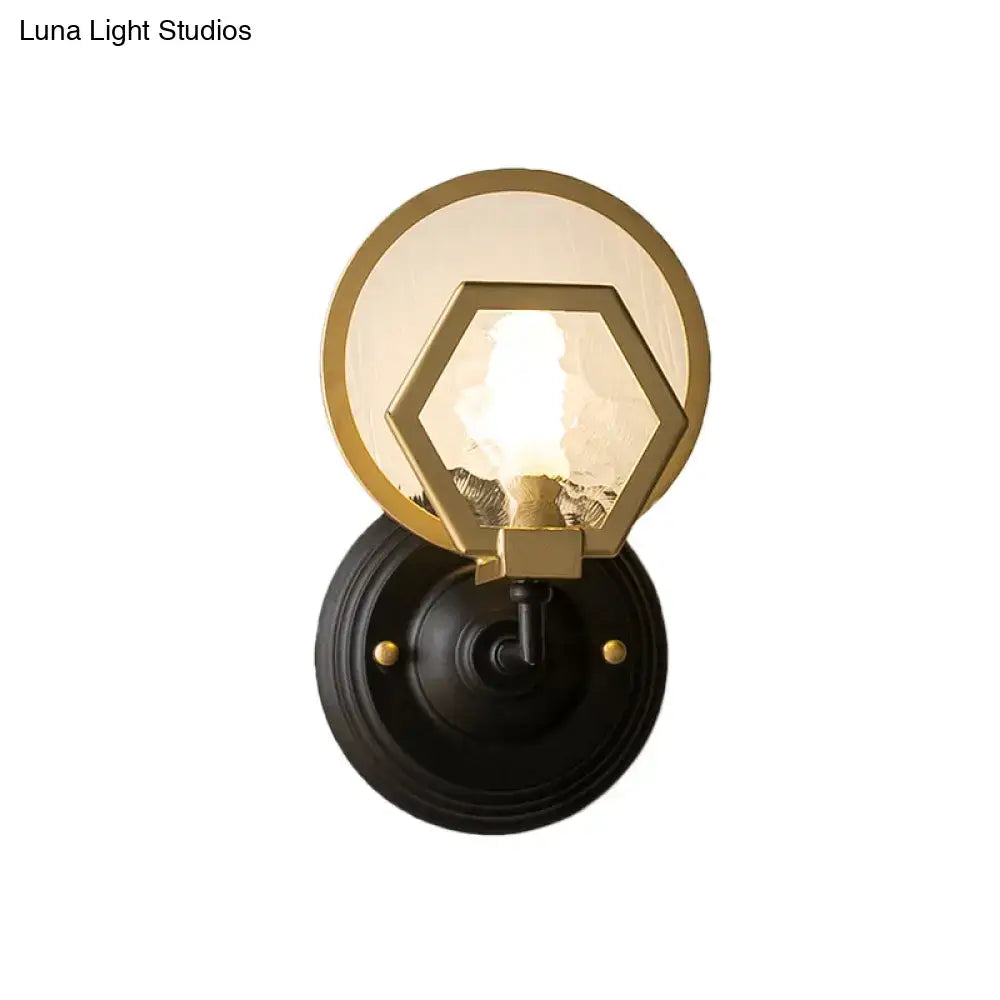 Gold-toned hexagonal glass wall lamp with black metal base and finish for vintage living space lighting