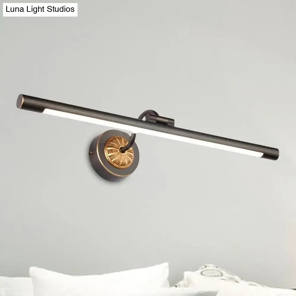 Modern black gold finish wall light with a sleek bar design and gold-toned circular base for bathroom vanity