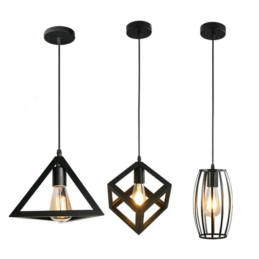 Three black iron pendant lights with geometric design and exposed filament bulbs as vintage dining room light source