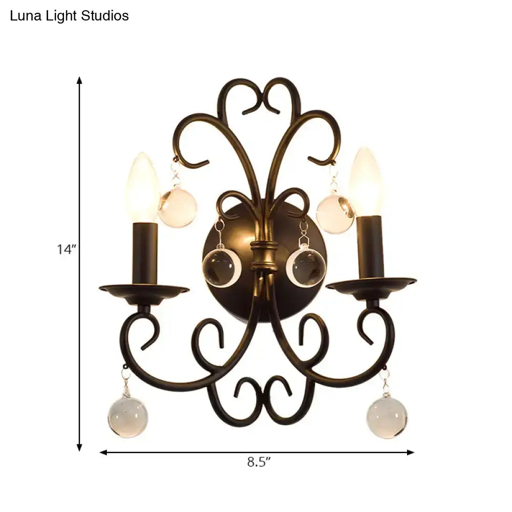 Antique bronze two-light wall light with ornate scrollwork and crystal ball deco frosted glass orbs for living room