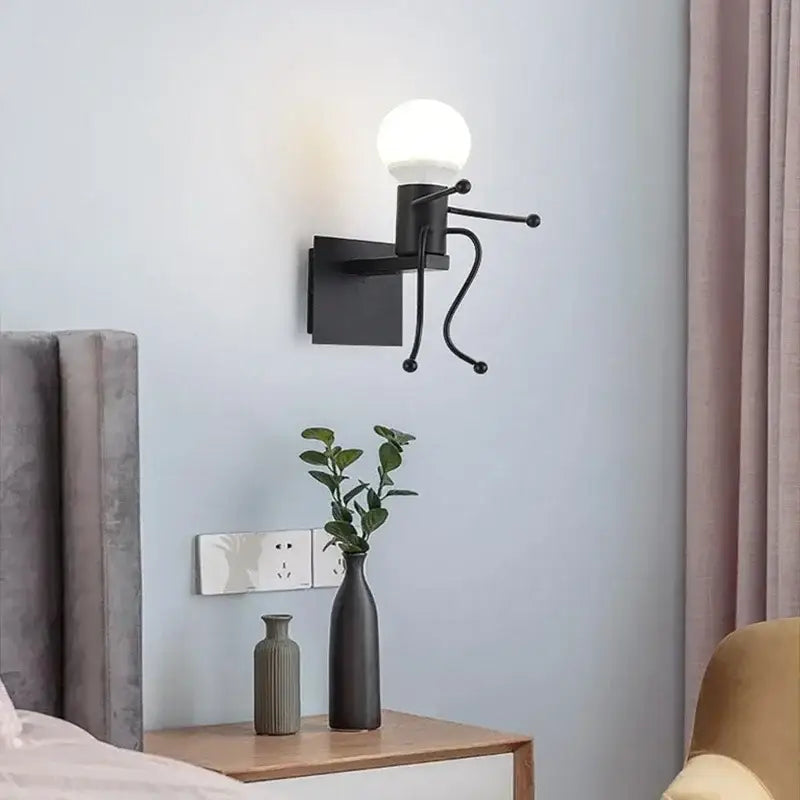 Vintage black man iron pendant light featuring a black metal wall sconce with a spherical glass bulb and articulated arm