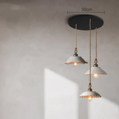 Three ceramic vintage hanging pendant lights with white scalloped shades and brass accents for kitchen decorbites decor