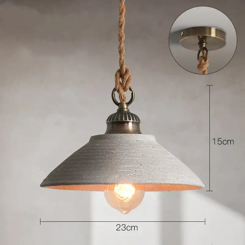 Industrial-style pendant lights with textured gray concrete shade brass hardware and natural fiber rope suspension decorbites ceramic vintage