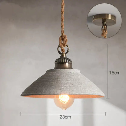 Industrial-style pendant lights with textured gray concrete shade brass hardware and natural fiber rope suspension decorbites ceramic vintage