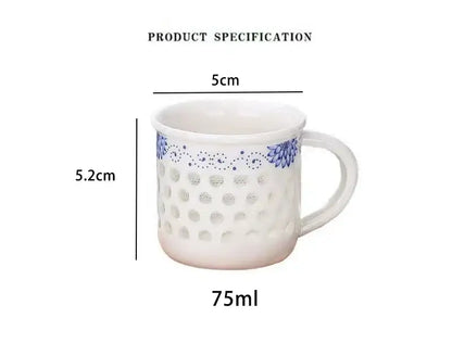White ceramic tea cup set with blue floral dot patterns and perforated design for vintage dining room use