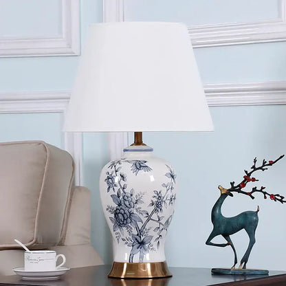 White porcelain table lamp with blue floral design and gold toned base for vintage decorbites blue white decor