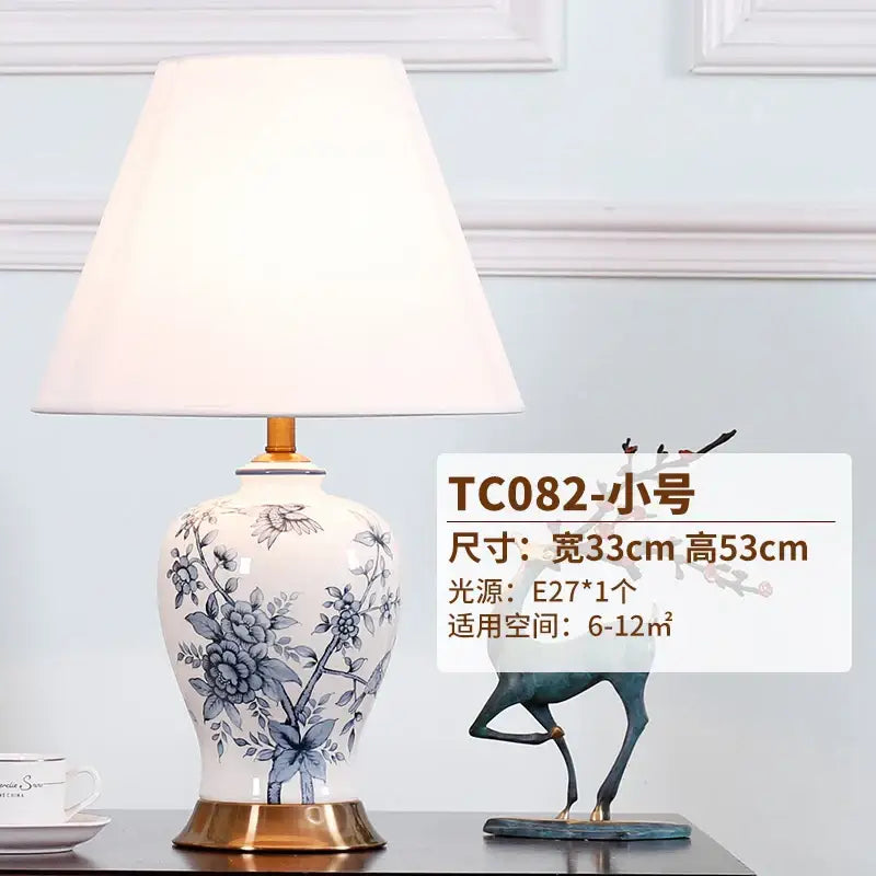 White porcelain table lamp with blue floral hand-painted design gold-toned base and cream fabric shade decorbites blue white