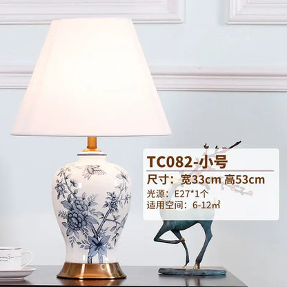 White porcelain table lamp with blue floral hand-painted design gold-toned base and cream fabric shade decorbites blue white