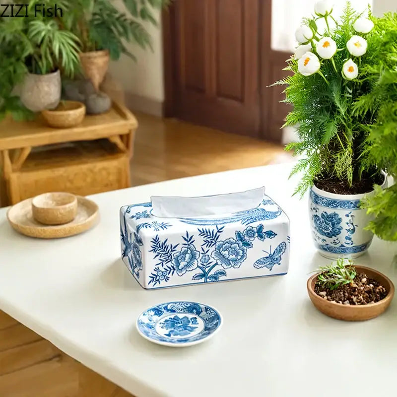Vintage blue and white porcelain tissue box decorated with floral and butterfly motifs for living room decor