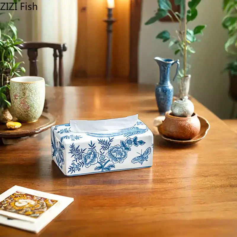 Vintage blue and white porcelain tissue box with floral and butterfly design for living room decor