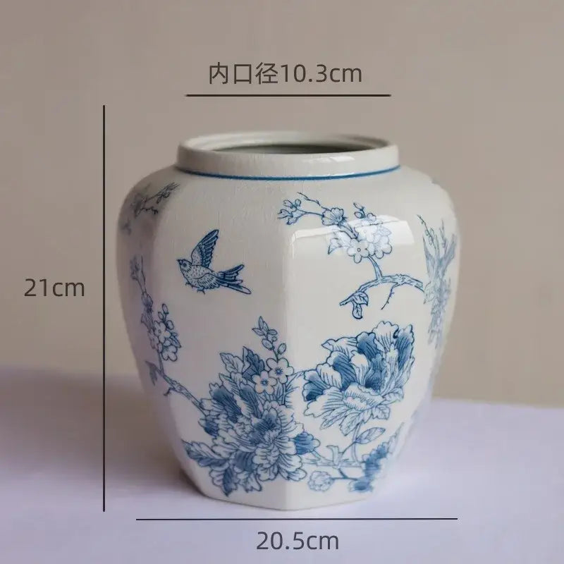 A white hexagonal porcelain vase with intricate blue white porcelain bird and floral hand-painted designs for living room decorbites blue white decor