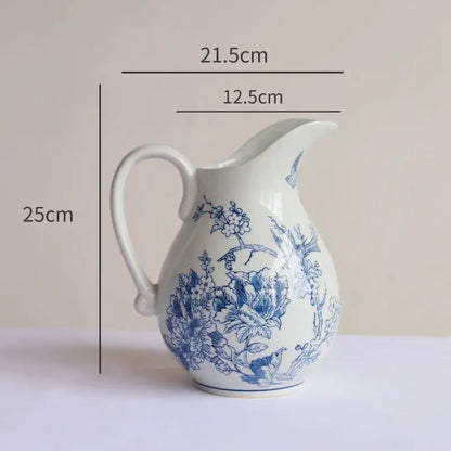 A white porcelain vase with blue floral and butterfly designs for living room decor by decorbites blue white