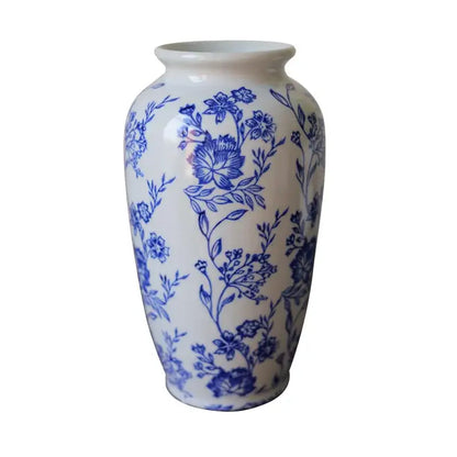 A vintage blue white porcelain vase with intricate floral patterns for living room decor by decorbites porcelain vase