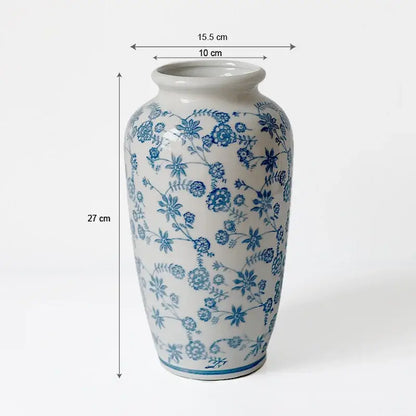 A tall porcelain vase with intricate blue floral patterns and a glossy finish for living room decorbites blue white decor