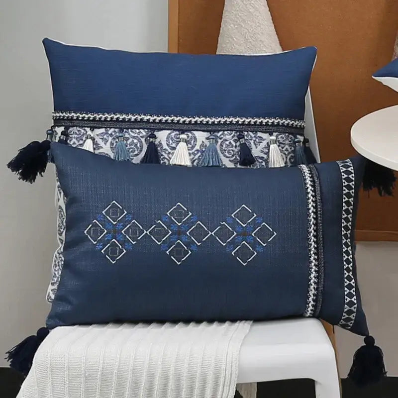 Navy blue rectangular pillow cover with white and light blue geometric embroidery and decorative blue tassels decorbites blue tassel