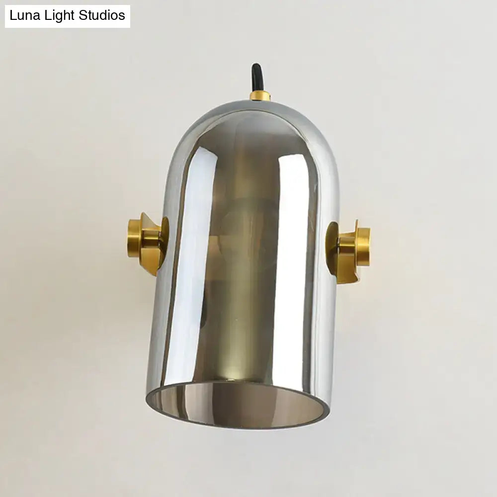 Modern chrome-finished pendant light with brass accents and dome design as a swivel shade cloche bedside sconce