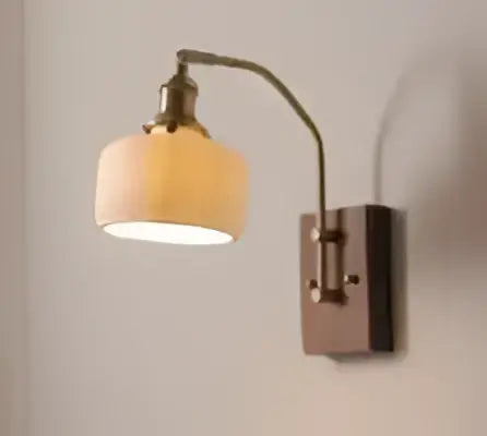 Antique brass led wall lamp with textured off-white fabric shade and amber glass for bedroom lighting