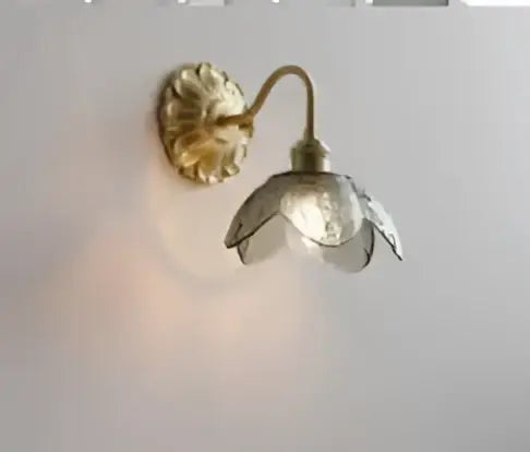 Vintage brass and amber glass led wall lamp featuring a gold-toned brass sconce with a translucent glass flower shade