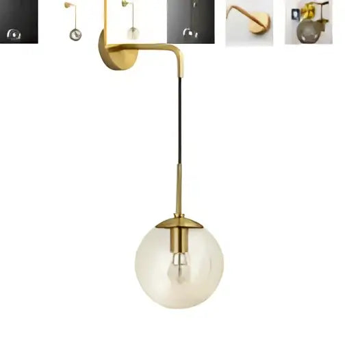 Gold-toned vintage brass and amber glass led wall lamp with spherical glass globe and exposed bulb for bedroom sconce