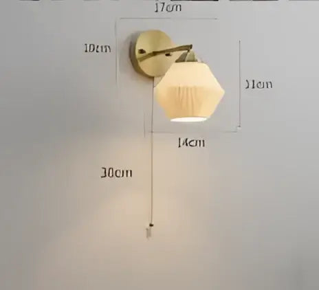 Vintage brass led wall lamp with amber frosted glass shade designed as a warm bedroom wall sconce