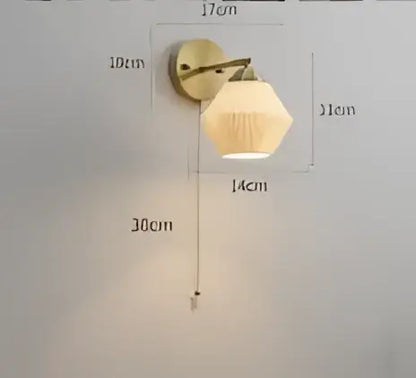 Vintage brass led wall lamp with amber frosted glass shade designed as a warm bedroom wall sconce
