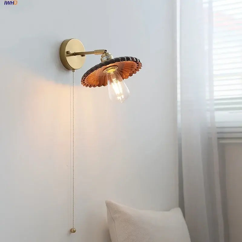 Vintage brass wall lamp with scalloped amber glass shade and exposed Edison bulb enhancing walnut wood decorbites LED walnut