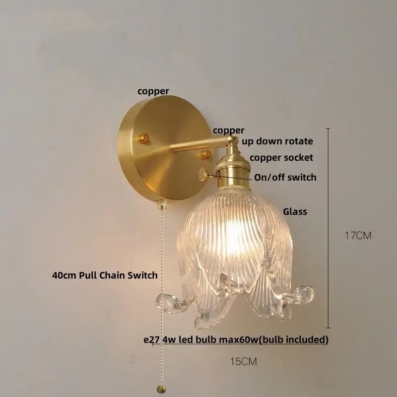 Vintage brass and amber glass wall light featuring a gold-toned copper flower sconce with loft amber glass shade