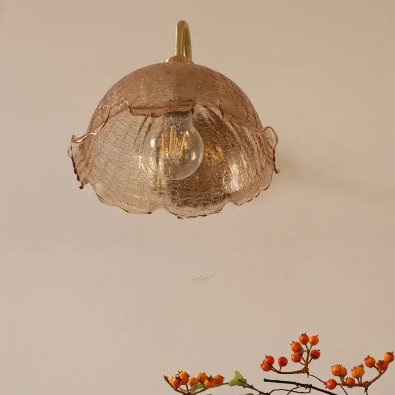 Vintage brass wall sconce with a decorbites amber glass wall lampshade featuring a textured crackled finish and ruffled edges