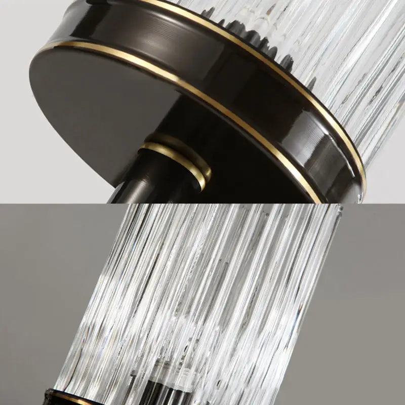Vintage brass and black wall lamp with clear ribbed glass cylinder shades and dark bronze base accented by gold trim