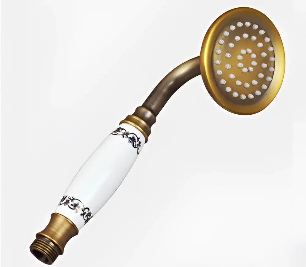 Vintage brass and ceramic handheld shower head with white ceramic and black floral detailing for bathroom use