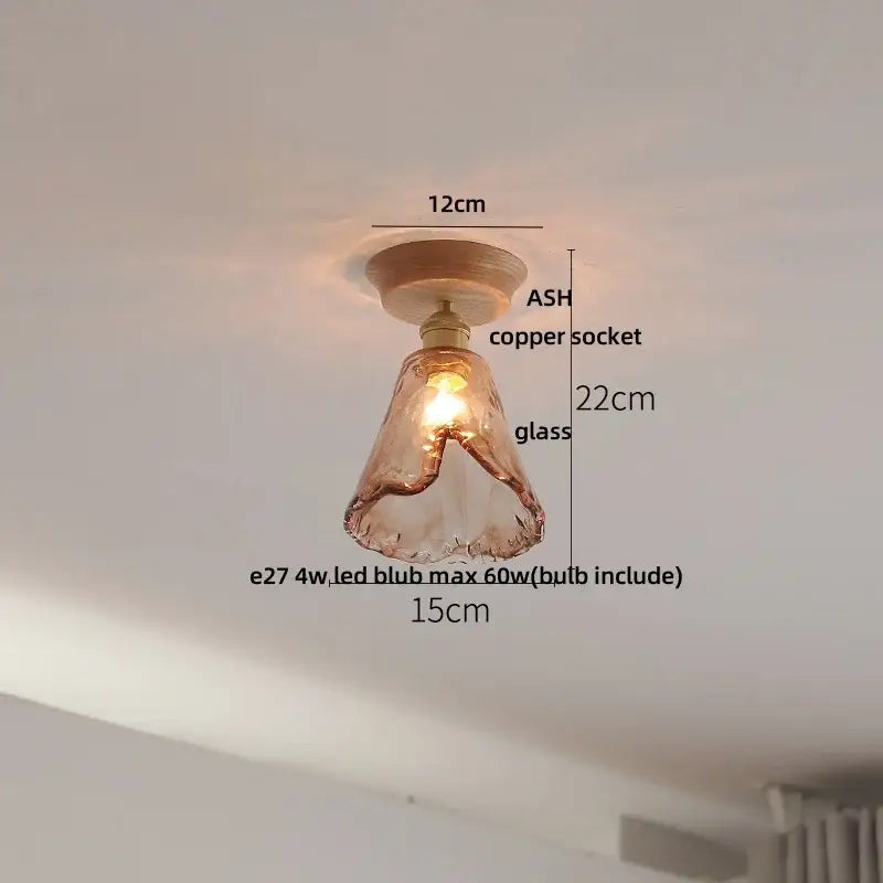 Vintage brass and clear glass led ceiling light featuring warm-toned hand-blown glass with a copper socket and ash wood base