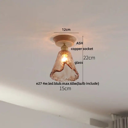 Vintage brass and clear glass led ceiling light featuring warm-toned hand-blown glass with a copper socket and ash wood base