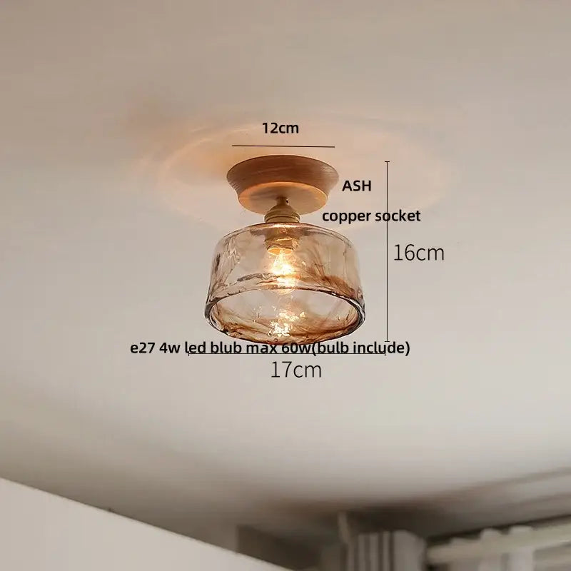Vintage brass and clear glass led ceiling light featuring warm amber glass pendant with copper socket and wooden base for bedroom decorbites clear glass
