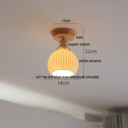 A warm-toned white ceramic ceiling light with copper socket and ash wood mount for decorbites clear glass led collection