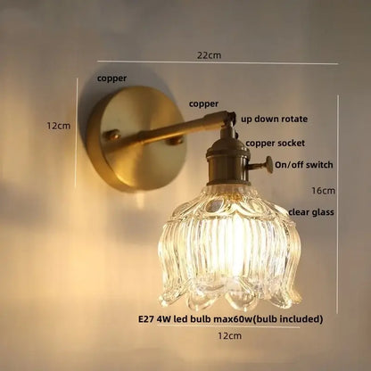 Vintage brass wall lamp with clear glass shade and pull chain switch for bedroom lighting in antique copper finish