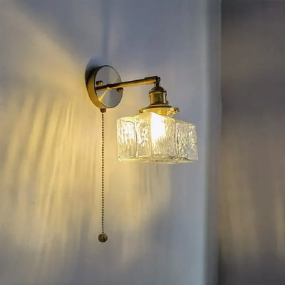 Vintage brass and glass led wall lamp with textured clear glass cube shade and pull chain for bedroom lighting