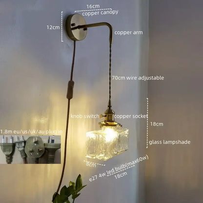 Vintage brass and glass led wall lamp with an antique brass finish, textured glass shade, and adjustable cord pull chain light