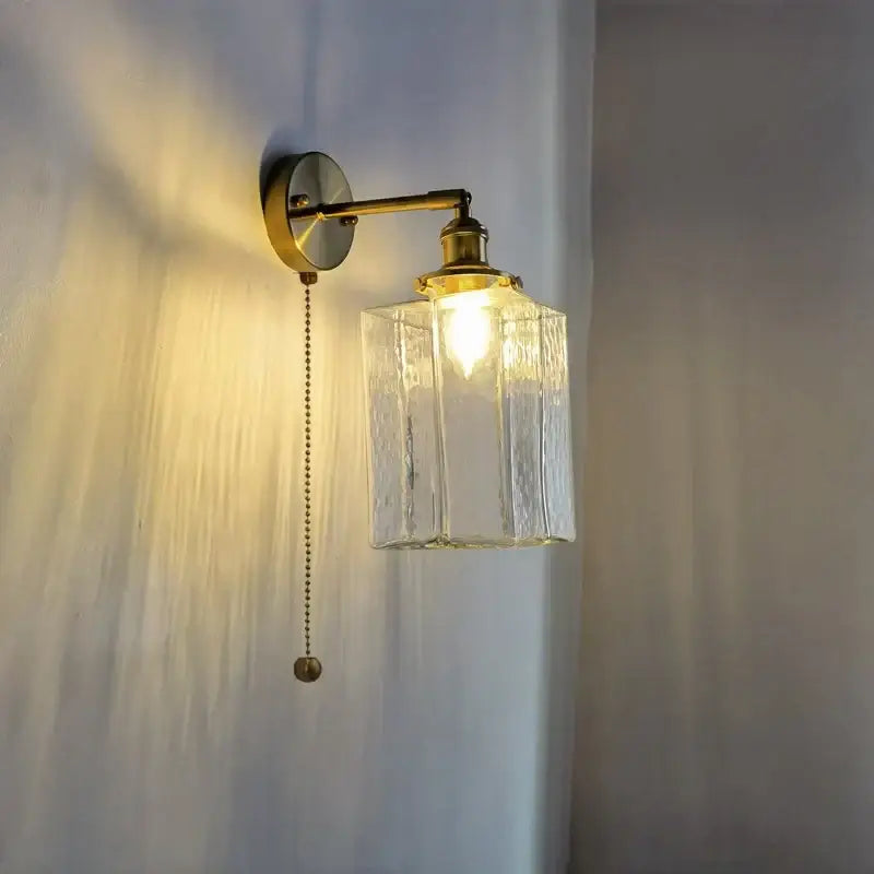 Vintage brass led wall lamp with clear textured glass shade and pull chain for bedroom lighting