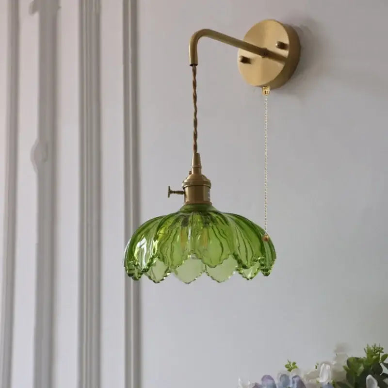 Vintage brass wall lamp with green glass led lotus shade featuring overlapping petal design for bedroom lighting