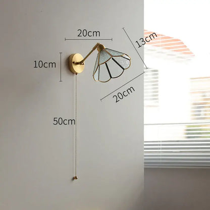 Gold-toned vintage brass wall lights with green glass led stained glass shade on circular brass base bedroom sconce