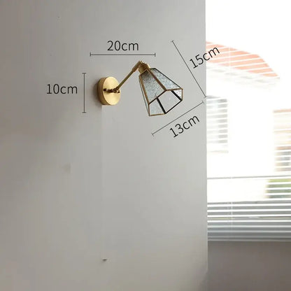 Vintage brass wall lights featuring a gold-toned sconce with a geometric green glass led shade for bedroom use