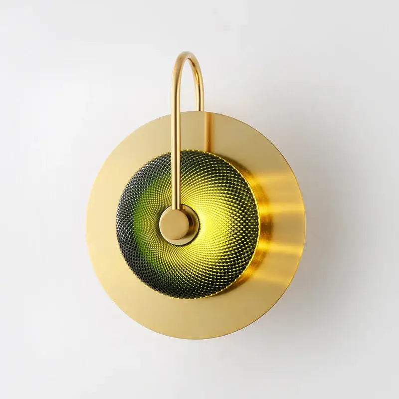 Vintage brass wall lamp with green glass circular textured diffuser combining metal wall art light for living room