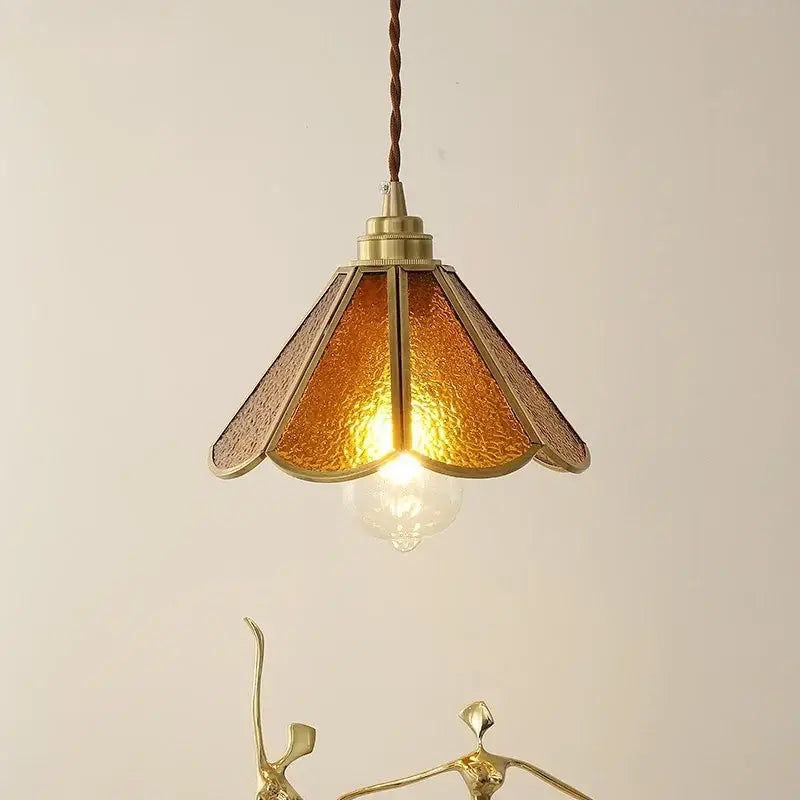 Vintage brass pendant light with warm amber glass and twisted brown cord for bedroom decor and decorbites blue glass collection