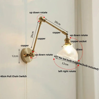 Adjustable copper wall light fixture with a textured glass shade in vintage brass and green glass for bedroom sconce use