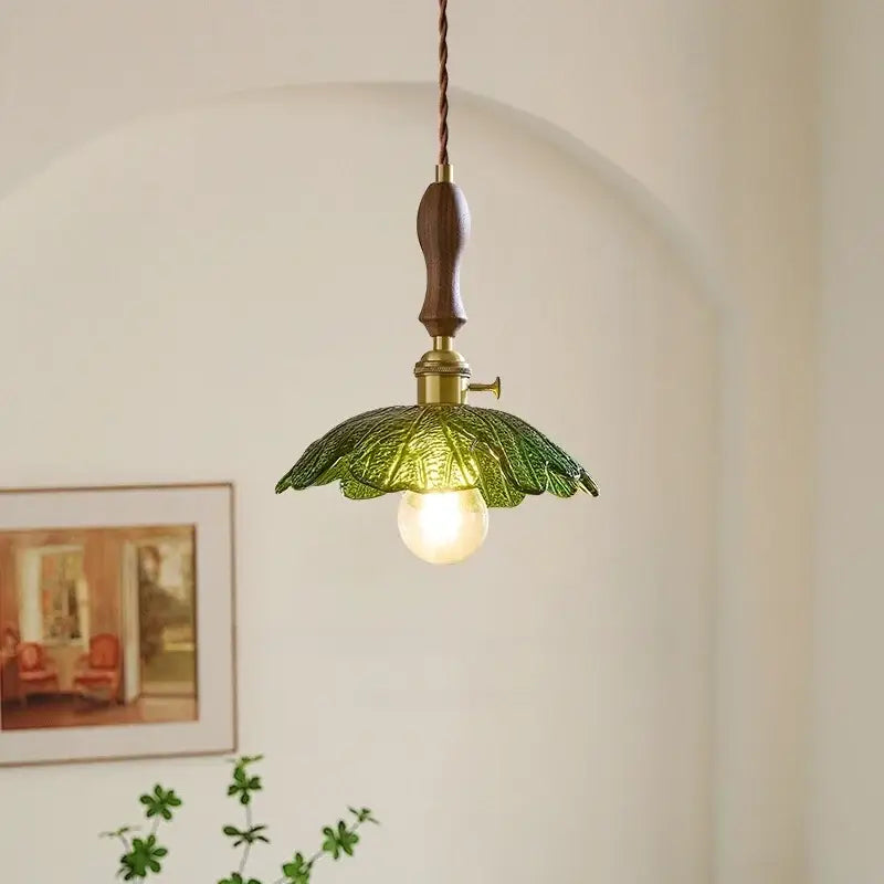 Vintage brass and green leaf led pendant lamp featuring a glass leaf design with wooden handle for dining room lighting