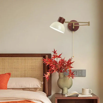 A modern wall lamp with brass arm, dark brown base and creamy iron led off-white conical shade by decorbites creamy iron