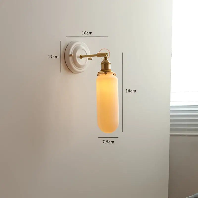 Vintage brass and ribbed amber glass led wall light designed as a bedroom sconce with warm lighting features