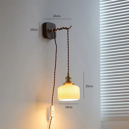 Vintage brass and ribbed glass led wall sconce with warm-toned glass and dark brown cord for bedroom decorbites led wall lighting