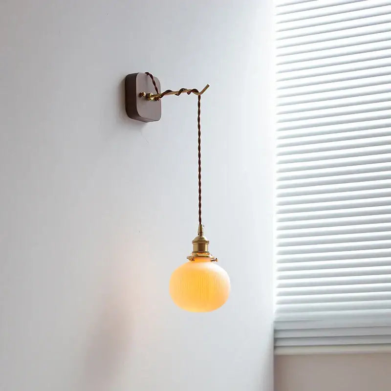 Warm amber glass globe led wall sconce with vintage brass hardware and twisted brown cord for bedroom decorbites led wall use