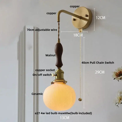 Vintage brass ceramic knob wall lights featuring a ribbed glass sconce with walnut-finished wooden handle